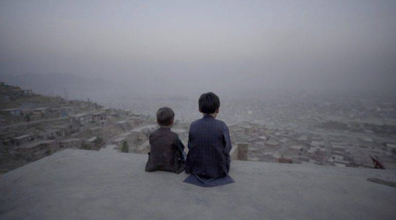 Kabul-Dystopian-Symphony-Benjamin-and-Afshin-in-rooftop.thumb.jpg.1b21be1f84cce455832c37cd64827771.jpg